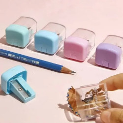 Mini taille-crayon avec couvercle et réservoir transparent Faber Castell. Disponible en quatre couleurs : bleu, rose, vert et vi
