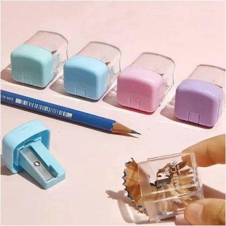 Mini taille-crayon avec couvercle et réservoir transparent Faber Castell. Disponible en quatre couleurs : bleu, rose, vert et vi