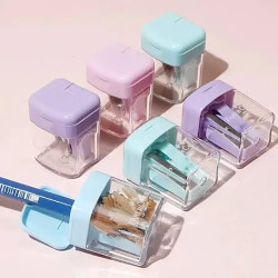 Mini taille-crayon avec couvercle et réservoir transparent Faber Castell. Disponible en quatre couleurs : bleu, rose, vert et vi